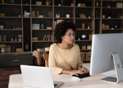 A woman teleworks from a home office.