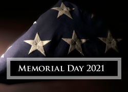 A folded American flag with the text Memorial Day 2021