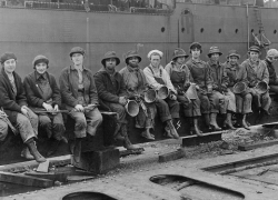 Women industrial workers in 1920 sitting on a steel beam