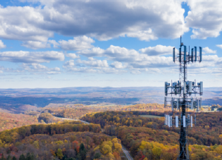 Cell phone or mobile service tower in forested area of West Virginia providing broadband service - stock photo