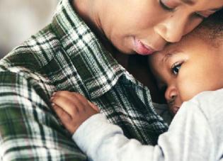 Woman holding a baby.