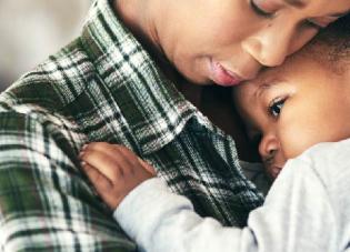 Woman holding a baby. 