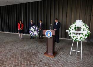 Secretary Walsh and USDOL Representatives taking a moment of silence at the Department of Labor headquarters.