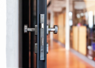 Open door to a sunlit office.