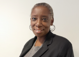 Professional headshot of a woman in a suit jacket.