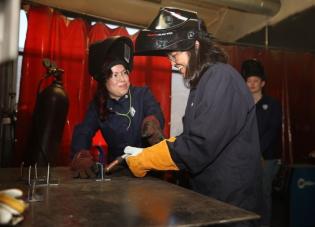 Acting Labor Secretary Julie Su learns to weld during a visit to Chicago Women in Trades, an organization that prepares women for good jobs. 