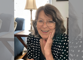 Headshot of Jeannie Ayer, smiling in a living room.