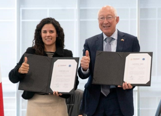 U.S. Ambassador Ken Salazar and Luisa María Alcalde, Mexico’s secretary of labor and social welfare, hold up signed documents as part of the ceremony to launch the pilot program.
