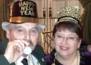 Trish Gallagher and her husband Tom wearing New Year's Eve hats. 