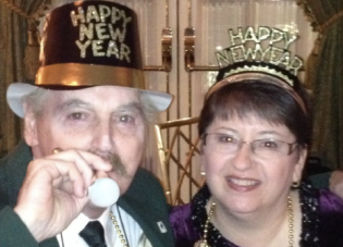 Trish Gallagher and her husband Tom wearing New Year's Eve hats.