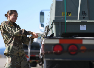 An airman secures a munitions kit to a flatbed truck at Ellsworth Air Force Base, South Dakota, Oct. 21, 2019. Photo by Air Force Airman 1st Class Christina Bennett.
