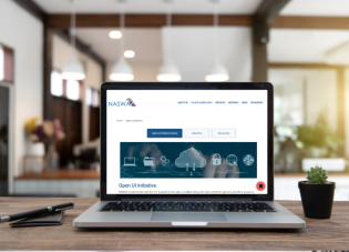 A laptop is open to a webpage reading NASWA Open UI Initiative.