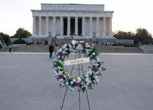 A wreath with the words "Workers Memorial" in front of the Lincoln Memorial in Washington, D.C.
