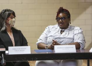 Wendy Chun-Hoon listens to Kimber Washington speak at a roundtable in Alabama.