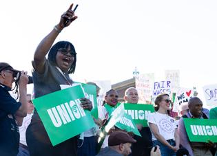 A group of union workers hold signs that read "union"